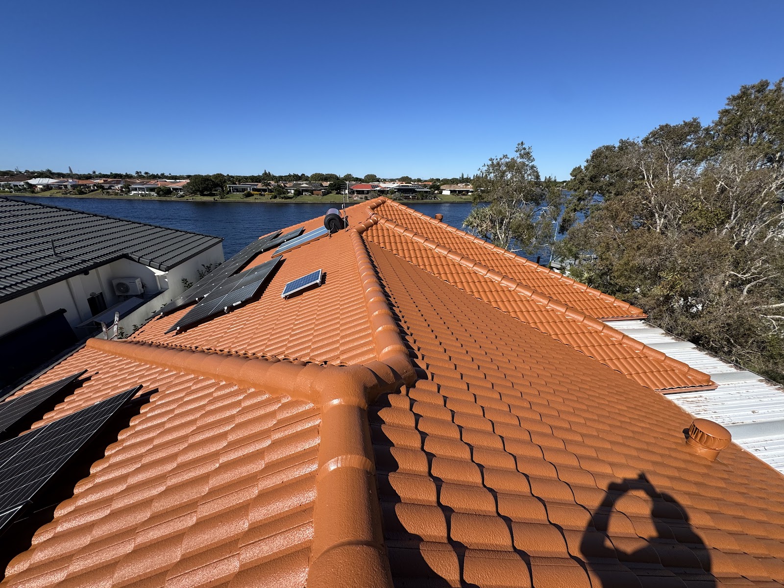 Freshly painted terracotta tile roof overlooking a canal at Noosa